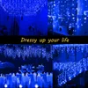 A collage of images showing blue LED icicle lights used for decoration indoors and outdoors, including on a ceiling, a shelf, a table setting, and a staircase. Náhľad obrázku produktu