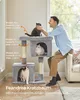 A man is interacting with cats on a cat tree in a living room. Produktbild-Vorschau