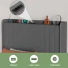 A close-up view of a headboard with integrated charging ports and decorative items. Produktbild-Vorschau