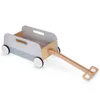 A wooden toy wagon with a pull handle, shown on a white background. Produktbild-Vorschau