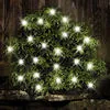A bush decorated with white LED lights, likely in a garden setting at dusk. Anteprima dell’immagine prodotto