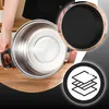 A person is holding a stainless steel pot, with a close-up of the pot's interior and a graphic illustrating layers. Voir les images du produit