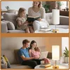 A split image showing a family reading and a couple using a laptop, both in a living room setting with a table lamp. Produktbild-Vorschau