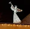A lighted angel decoration on a dark background, with icicles hanging from a ledge below. Náhled obrázku produktu