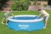 A man and a woman are interacting with a blue inflatable pool in a grassy backyard. Produktbild-Vorschau