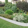 A garden bed with a metal border separating it from a lawn. Produktbild-Vorschau