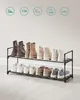 A two-tiered shoe rack with various types of footwear on display. Náhled obrázku produktu