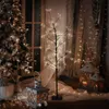 A decorative LED tree with warm white lights is displayed indoors, possibly as a Christmas decoration, alongside other festive elements like lanterns and a Christmas tree. Podgląd zdjęcia produktu