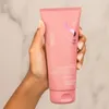 A hand holding a pink tube of Semi Di Lino Moisture Dry Hair Leave-in Conditioner. Produktbild-Vorschau