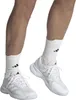A close-up shot of a person's legs wearing white Adidas tennis shoes and white socks. Produktbild-Vorschau