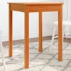 A wooden table with four legs on a rug. Anteprima dell’immagine prodotto