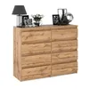 A wooden dresser with eight drawers is displayed against a white background, with decorative items on top. Produktbild-Vorschau