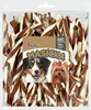 A clear plastic bag filled with dog treats, with a label featuring two dogs and product information. Náhľad obrázku produktu