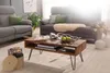A living room scene with a coffee table in the foreground and sofas in the background. Náhled obrázku produktu