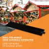 A black heating mat is placed in the foreground against a background of a Christmas market with wooden stalls decorated for the holidays. Text overlays provide marketing information. Produktbild-Vorschau