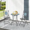 A patio set with a mosaic table and two chairs on a deck with a patterned rug. Produktbild-Vorschau