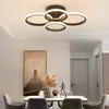 A modern dining room with a ceiling lamp, a table, chairs, and artwork. Náhľad obrázku produktu