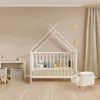 A nursery room with a crib, storage baskets, and a bunny-shaped stool. Produktbild-Vorschau