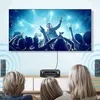 Two people are watching a concert on a large TV, with a stereo receiver and speakers set up in front of them. Náhled obrázku produktu