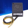 A black power unit with yellow and black wires attached, set against a blue and white background. Náhled obrázku produktu