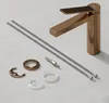A faucet and its installation accessories are laid out on a light gray surface. Anteprima dell’immagine prodotto