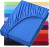 A stack of colorful fitted sheets, with the top one in royal blue prominently displayed. Produktbild-Vorschau