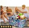 People enjoying a picnic on the beach with a picnic basket filled with food. Náhled obrázku produktu