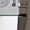 A close-up view of a modern bathroom sink and shower enclosure. Voir les images du produit
