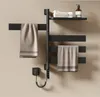 A black electric towel warmer with towels and a soap dispenser on a shelf. Anteprima dell’immagine prodotto