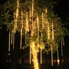 A tree decorated with string lights at night. Náhled obrázku produktu