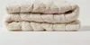 A folded cream-colored fleece matress topper. Anteprima dell’immagine prodotto