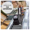A man holding a child on an escalator in a shopping mall, with a folded stroller next to him. Produktbild-Vorschau