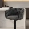 A dark gray bar stool with a tufted seat and backrest is shown in a modern kitchen setting. Produktbild-Vorschau