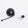 A black fuel tank cap with a tether and two keys on a white background. Produktbild-Vorschau