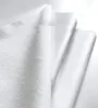 A close-up view of a folded white fabric, likely a mattress protector. Náhľad obrázku produktu