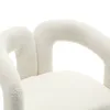 A close-up view of a textured, cream-colored armchair. Anteprima dell’immagine prodotto