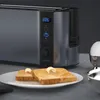A toaster with toast and an egg cup on a countertop. Anteprima dell’immagine prodotto