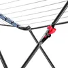 Close-up of a black folding clothes drying rack with a red clip attached to one of its supports. Náhľad obrázku produktu