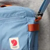 Close-up of a blue Fjällräven crossbody bag with orange accents. Anteprima dell’immagine prodotto