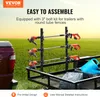 A trailer with a VEVOR trimmer rack mounted on it, loaded with trimmers and other gardening items, set against a grassy field and sunset background. Produktbild-Vorschau
