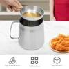 A hand is pouring oil from a small metal bowl into a larger metal pitcher. Below the pitcher are icons representing features and a plate of fried chicken. Podgląd zdjęcia produktu