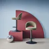 Two khaki bar stools are displayed in a studio setting with a red curved backdrop and a disco ball. Produktbild-Vorschau