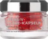 A close-up studio shot of a glass jar containing red capsules, with text on the jar. Anteprima dell’immagine prodotto