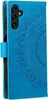 A blue flip case for a Samsung Galaxy A54 5G phone with a mandala design embossed on the cover. Produktbild-Vorschau