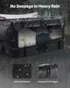 A car's cargo carrier bag filled with items, shown in the rain. Produktbild-Vorschau