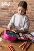 A young girl is organizing colored pencils in a pink pencil case on a wooden table. Anteprima dell’immagine prodotto
