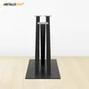A pair of black metal table legs on a wooden floor against a white wall. Voir les images du produit