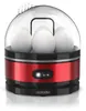 A red and black electric egg cooker with a clear lid, containing several white eggs, placed on a white reflective surface. Anteprima dell’immagine prodotto