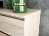 A close-up view of a wooden dresser with green decorative vases on top, set against a textured gray wall. Produktbild-Vorschau