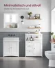 A modern bathroom setup featuring white furniture, including a vanity and a storage cabinet, with decorative items and a toilet. The walls are tiled in gray. Produktbild-Vorschau